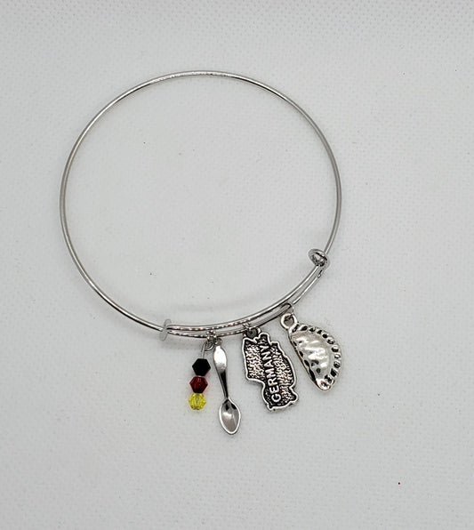 Silver German charm bracelet pierogi with map charm, spoon charm, and colored beads from Pierogi Gifts