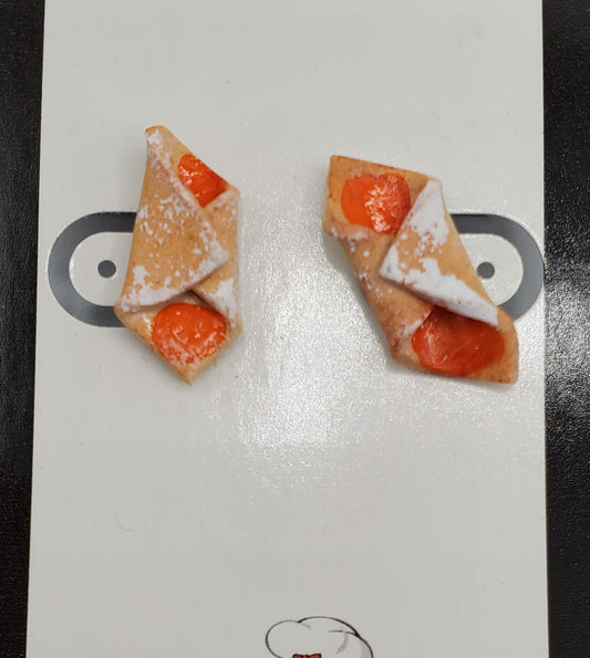 Kolache shaped earrings by Pierogi Gifts showcasing realistic pastry design with powdered sugar and orange filling
