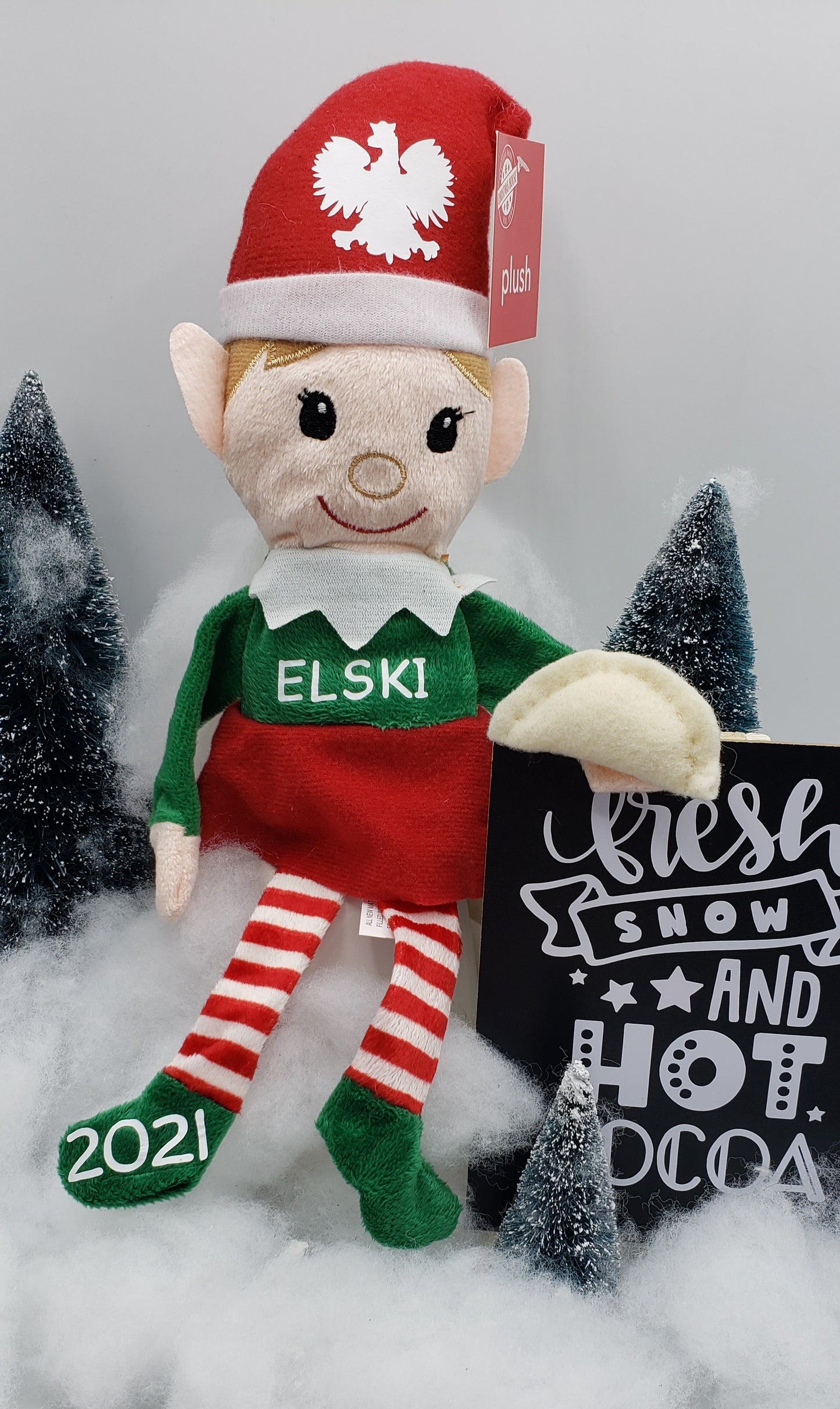 Elfski & Elski Polish Elves collectible doll wearing red and green outfit with 2021 on shoe and holding a dumpling