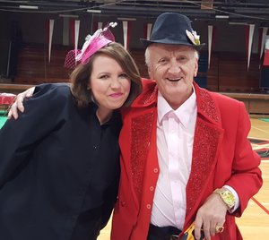 Black fedora pierogi hat worn by an elderly man with a red suit jacket and a white shirt