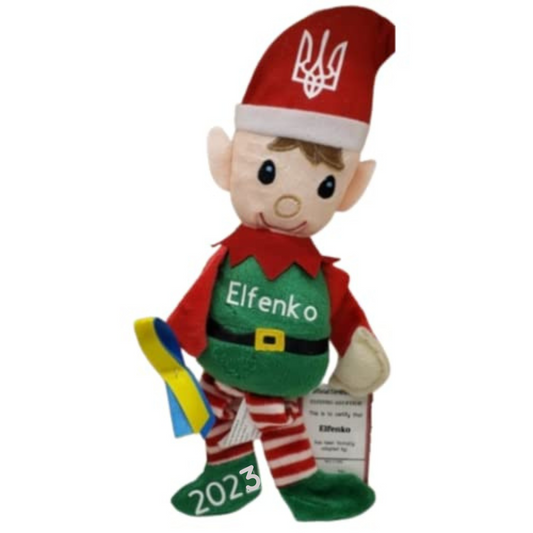 Elfenko The Ukrainian Elf Plush Doll wearing red and green outfit with 2023 on shoe and holding a yellow and blue ribbon