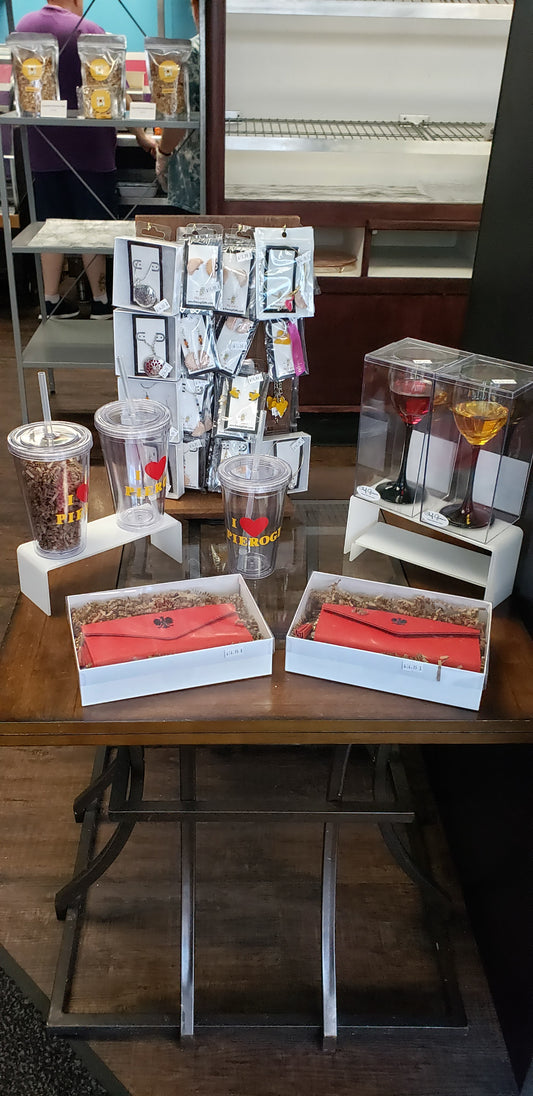 Wholesale pierogi display set featuring clear beverage dispensers and packaged gift items on a wooden table
